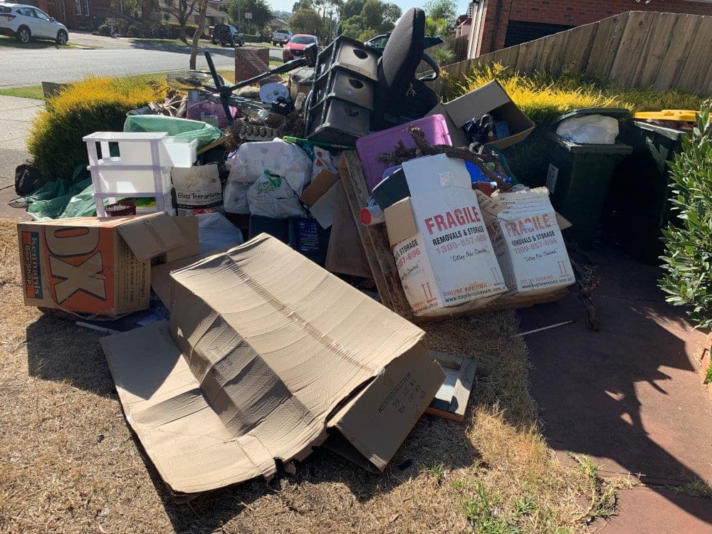 Boxes, cardboard and household items piled at the kerb, ready for collection